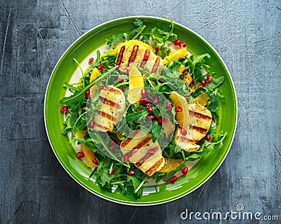 Grilled Halloumi Cheese salad with orange, rocket leaves, pomegranate and pumpkin seed. healthy food Stock Photo