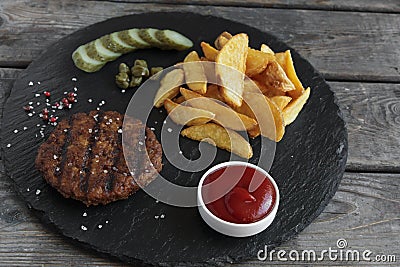 Grilled hamburger with potatoes and pickled cucumber sauce Stock Photo
