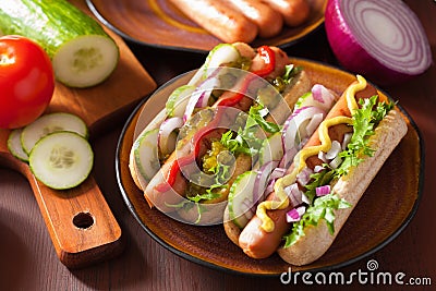 Grilled hot dogs with vegetables ketchup mustard Stock Photo