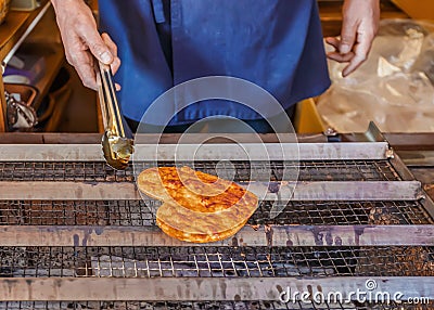 Grilled Japanese Senbei on a stove Stock Photo