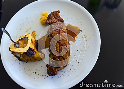 Grilled juicy Sirloin steak with potatoes on a white plate Stock Photo