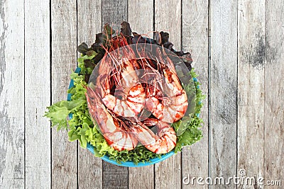 Grilled large fresh prawns served with megetables on blue plate Stock Photo