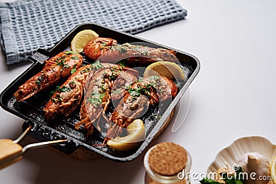 Grilled large queen shrimps with lemon and spices on the grill pan Stock Photo