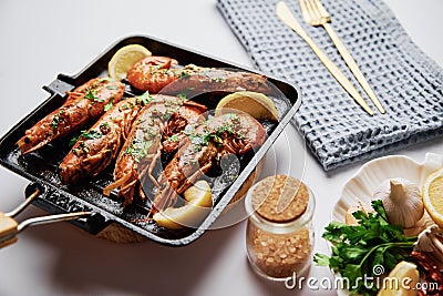 Grilled large queen shrimps with lemon and spices on the grill pan Stock Photo