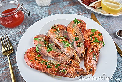 Grilled large queen shrimps with lemon and spices on the plate Stock Photo