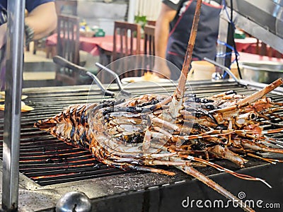 Grilled Lobster on a gridiron over fire at the seafood night market Stock Photo