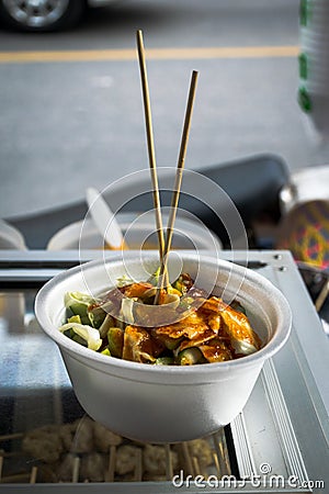 Grilled meat ball with sweet spicy sauce in styrofoam cups. Stock Photo