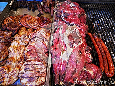 Grilled meats - sausages, pork and grilled chicken - smoked sheep on the right grill Stock Photo