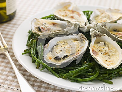 Grilled Oysters with Mornay Sauce on Samphire Stock Photo