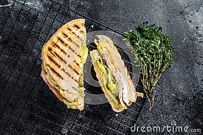 Grilled panini with Prosciutto ham, salad and cheese. Black background. top view Stock Photo