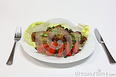 Grilled pork chops with tomatoes and lettuce Stock Photo