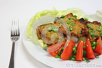 Grilled pork chops with tomatoes and lettuce Stock Photo