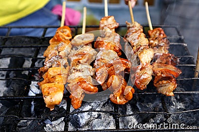 Grilled pork intestine in barbecue sticks sold at a street food stall Stock Photo