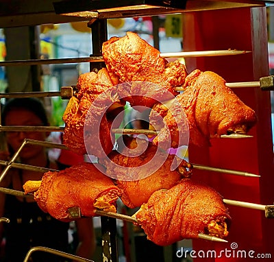 Grilled Pork Knuckles on a Spit Stock Photo