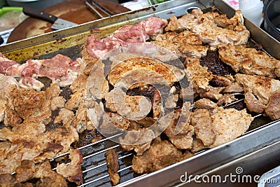 Grilled pork roasted on steel plate or grill In the street food market of Thailand is a culture of easy-to-buy. Tidy The food is p Stock Photo