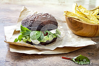 Grilled portobello bun mushroom burger. Vegan, gluten free, grain free, healthy veggies hamburger with guacamole, fresh vegetables Stock Photo