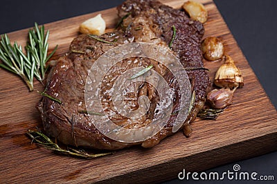 Grilled rib-eye steak of marble beef closeup with spices on wooden Board Stock Photo