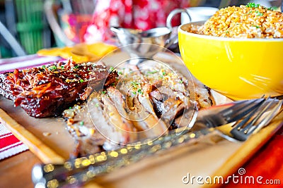 Grilled ribs and prok belly striped served with sauce and java rice Stock Photo