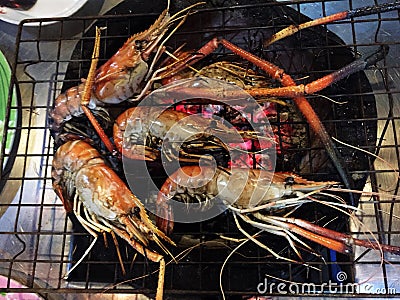 Grilled River Prawn or river shrimp on charcoal stove. Stock Photo