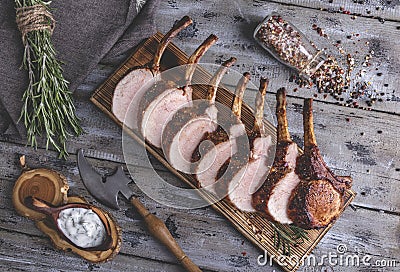 Grilled roasted rack of pork,slice meat chops on a portion wooden board Stock Photo