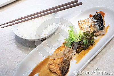 Grilled Saba fish and Salmon fish sauce with rice and chopsticks on table. Japanese food Stock Photo