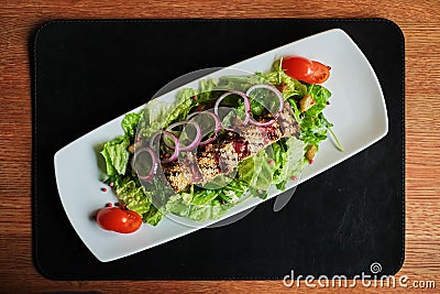 grilled salmon coated in sesame salad with bulgur and vegetables Stock Photo