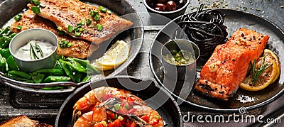 Grilled salmon fish fillet with lemon and strimps. Sea food dishes assorty. Healthy concept Stock Photo