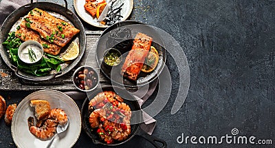 Grilled salmon fish fillet with lemon and strimps. Sea food dishes assorty. Healthy concept Stock Photo