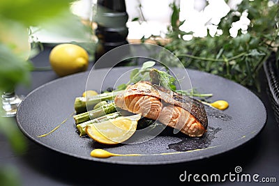 Grilled salmon on green asparagus. An elegant exquisite dish Stock Photo