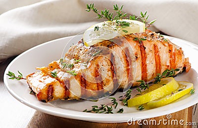 Grilled Salmon with lemon, olives and fresh thyme Stock Photo