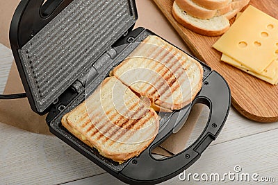 Grilled sandwiches in panini press Stock Photo