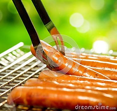 Grilled Sausage on the flaming Grill Stock Photo