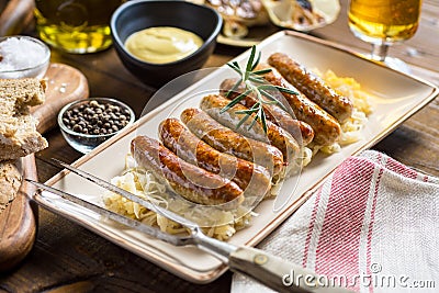 Grilled Sausages with Cabbage Salad, Mustard and Beer. Bratwurst and Sauerkraut. Stock Photo