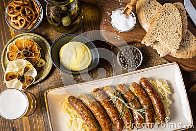 Grilled Sausages with Cabbage Salad, Mustard and Beer. Bratwurst and Sauerkraut. Stock Photo