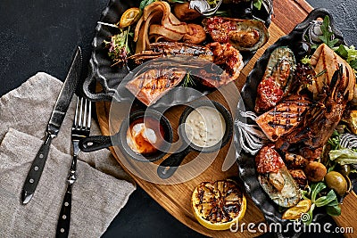 grilled seafood platter. Assorted delicious grilled seafood with vegetables. Grilled mixed bastards with pepper sauce Stock Photo