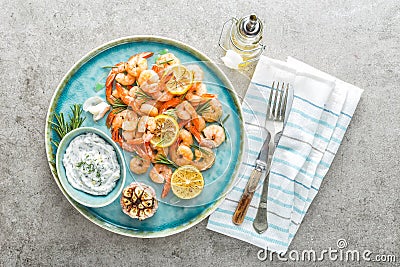 Grilled shrimps or prawns served with lemon, garlic and sauce Stock Photo