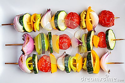 Grilled skewers vegetables on gray rectangular plate. Vegan food concept Stock Photo