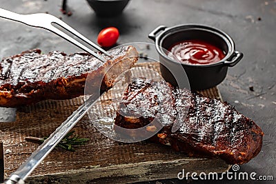 Grilled and smoked ribs with barbeque sauce. Delicious barbecued ribs. Food recipe background. Close up Stock Photo