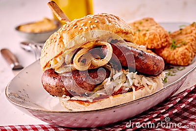 Grilled spicy bratwurst burger on a sesame bun Stock Photo
