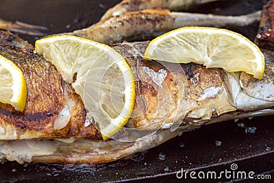 grilled spicy fish closeup. Cooking, the process. Fried fish for lunch or dinner. Stock Photo