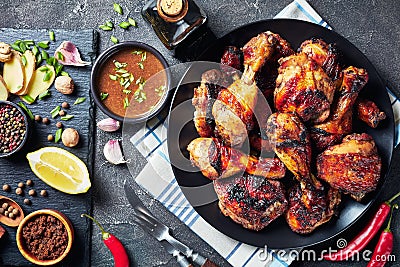 Grilled spicy Jerk Chicken drumsticks and thighs Stock Photo