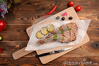 Grilled steak with lemon on a wooden background Stock Photo