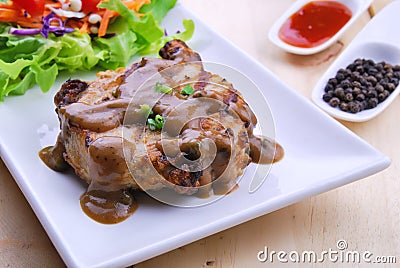 Grilled steaks, pork with pepper gravy and vegetable salad Stock Photo