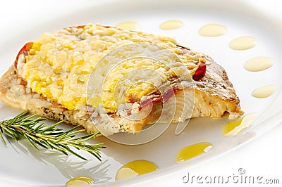 Grilled trout steak with cheese and prosciutto Stock Photo