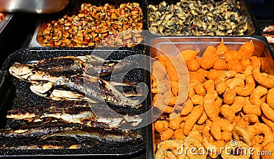 Grilled trouts, calamar rings and shells Stock Photo