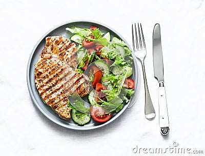 Grilled turkey chops and vegetables salad on a light background, top view. Healthy food diet concept Stock Photo