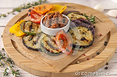 Grilled vegetables with fresh spicy greens and pesto sauce Stock Photo