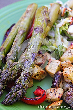 Grilled vegetables on plate closeup asparagus and onions potatoes Stock Photo