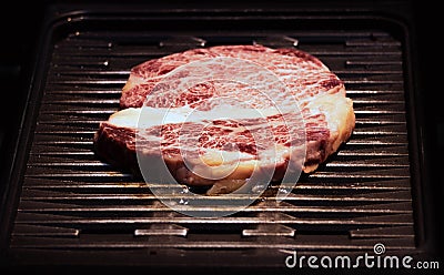 Grilled wagyu beef, Raw marble beef steak frying in black grill Stock Photo