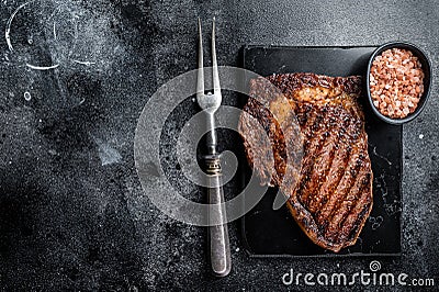 Grilled wagyu Rib Eye steak, marbled beef meat with salt. Black background. Top view. Copy space Stock Photo